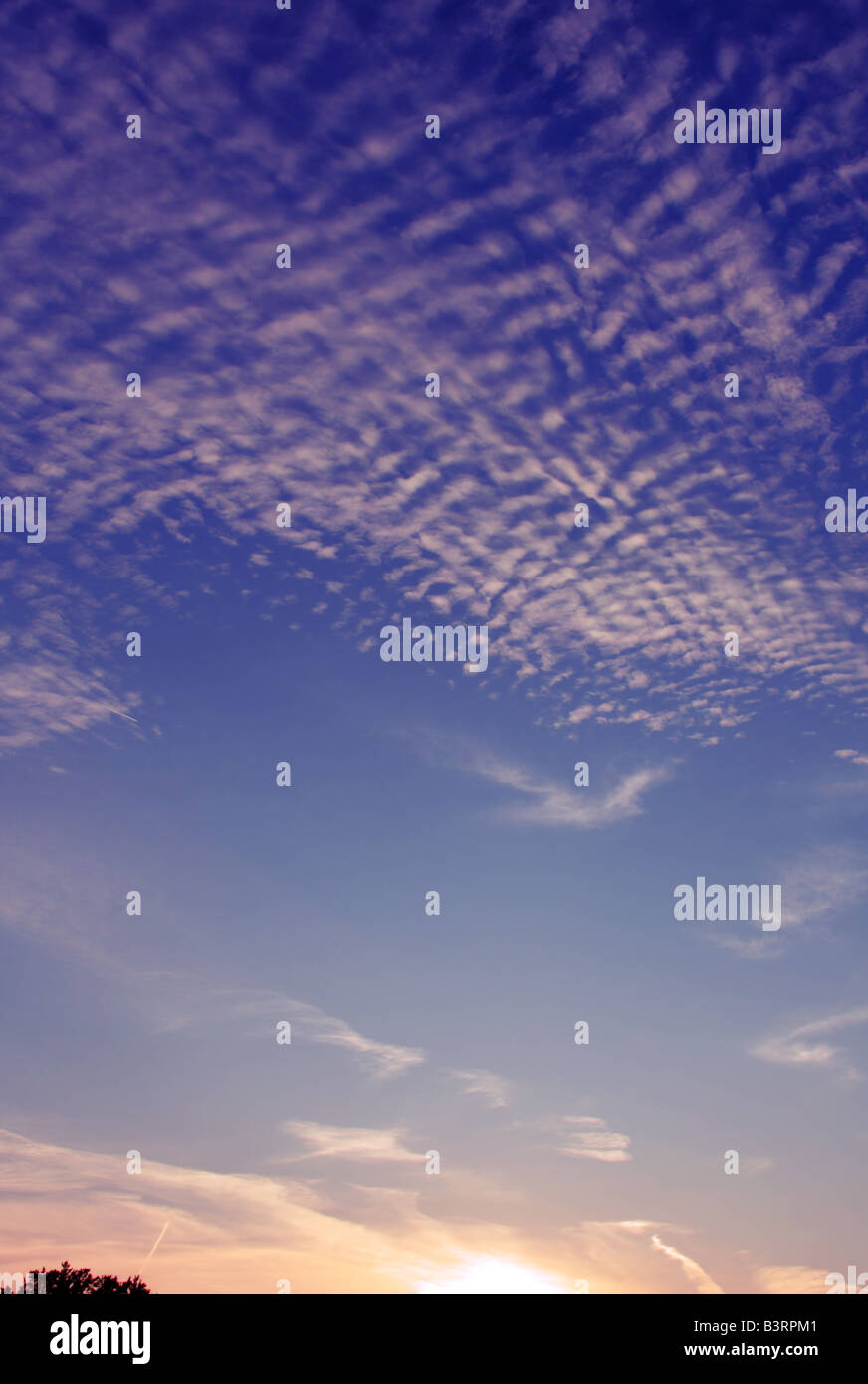 Cirrocumulus and Altocumulus clouds at sunset Stock Photo