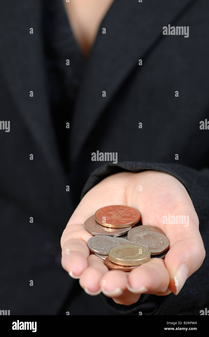 Woman Holding a Handful of British Coins Close Up Stock Photo