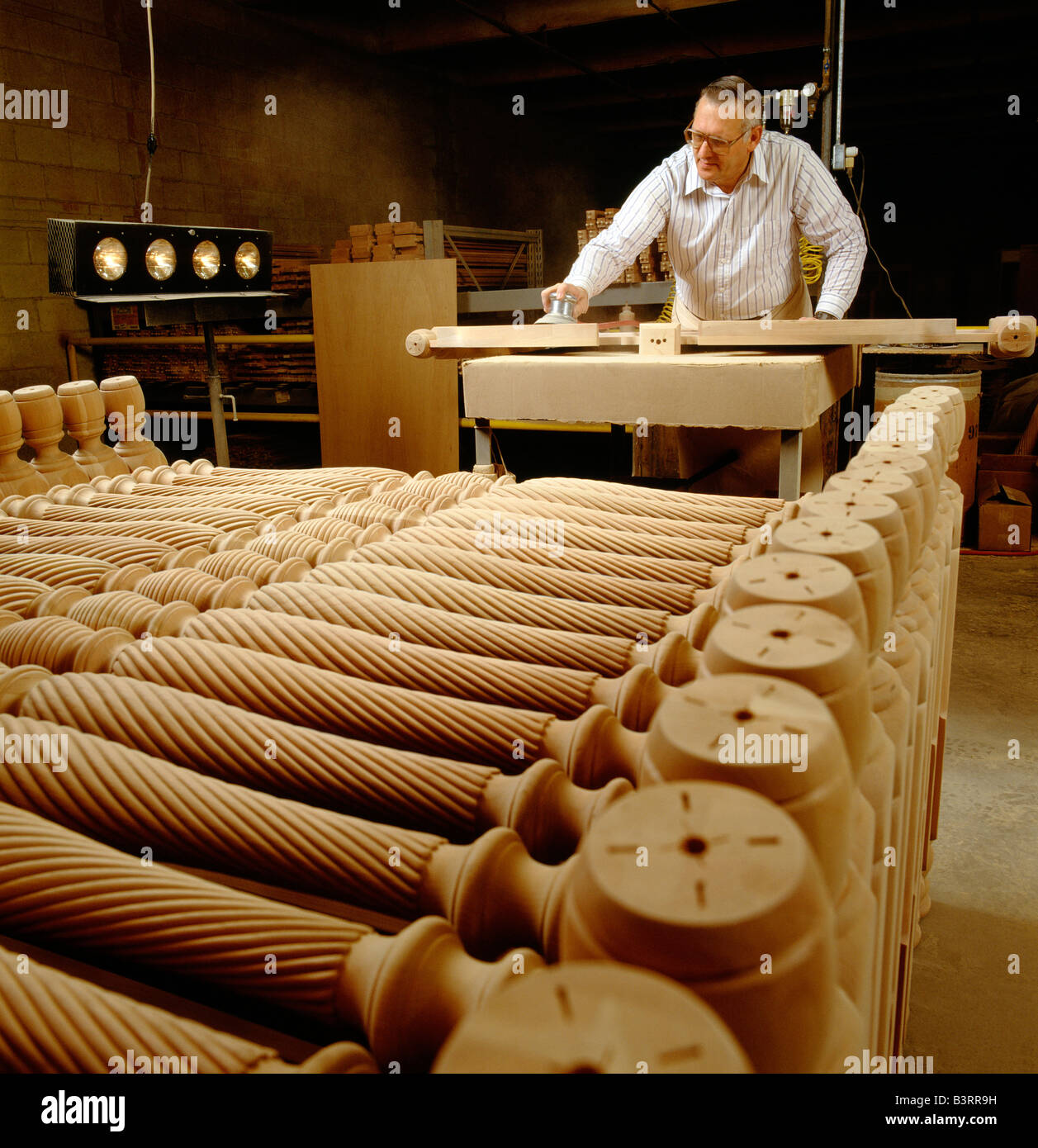 WORKER DOES THE FINAL SANDING TO A PIECE OF FURNITURE, PENNSYLVANIA