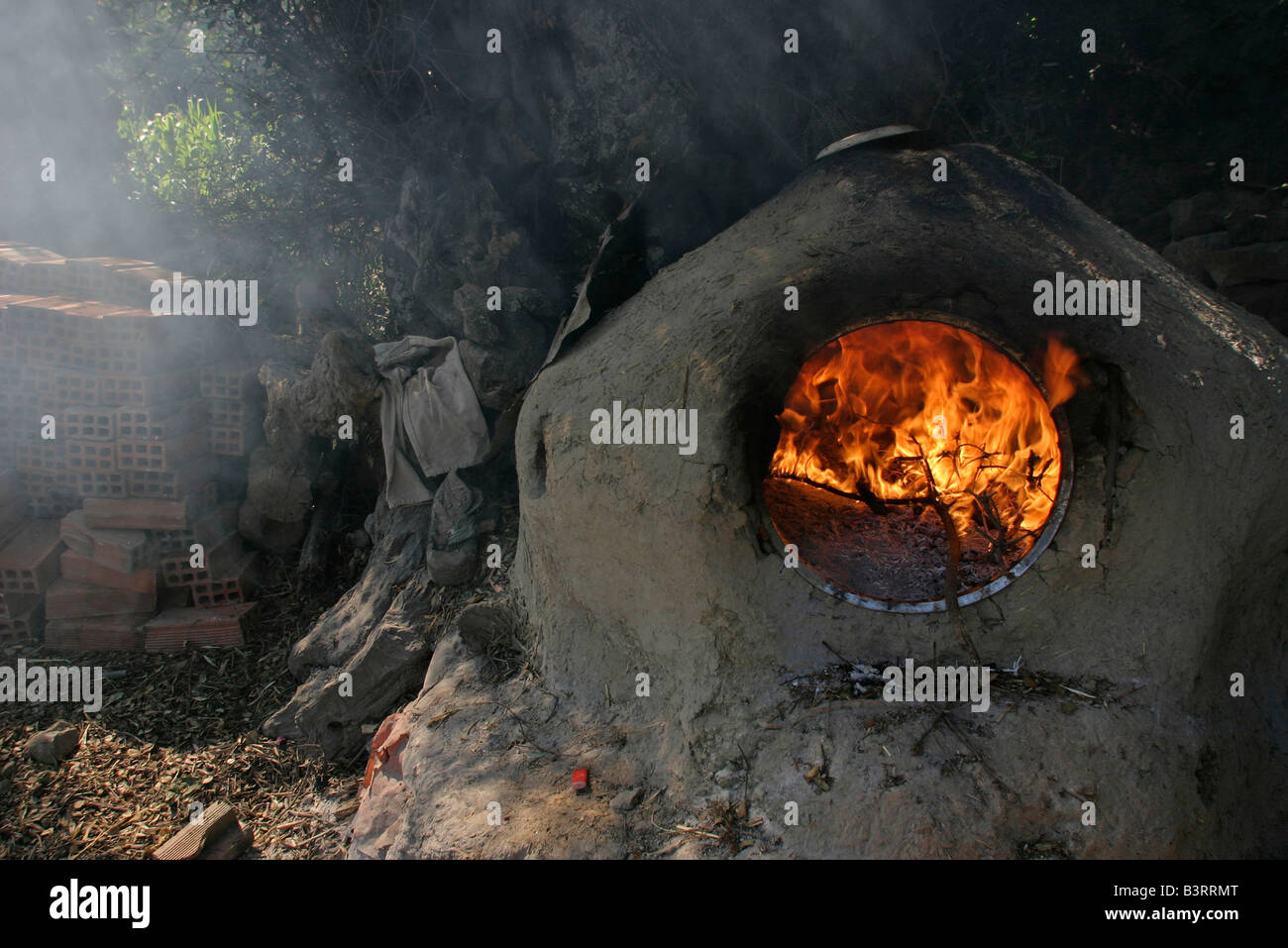 Villages of the Rif mountains women bake bread in traditional ovens which they first heat to high temperature with firewood. Stock Photo