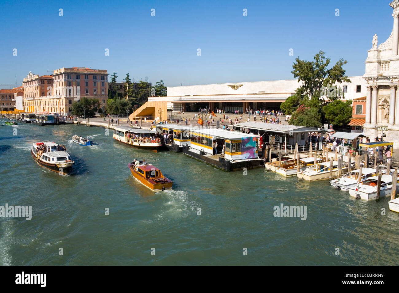 The moderrn Main Railway Station and the Grand Canal at Venice in Italy, where water taxis stop to take you onwards to the hotel Stock Photo