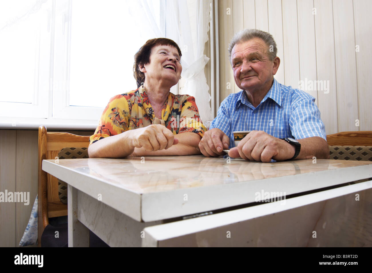 Happy senior couple in kitchen Stock Photo
