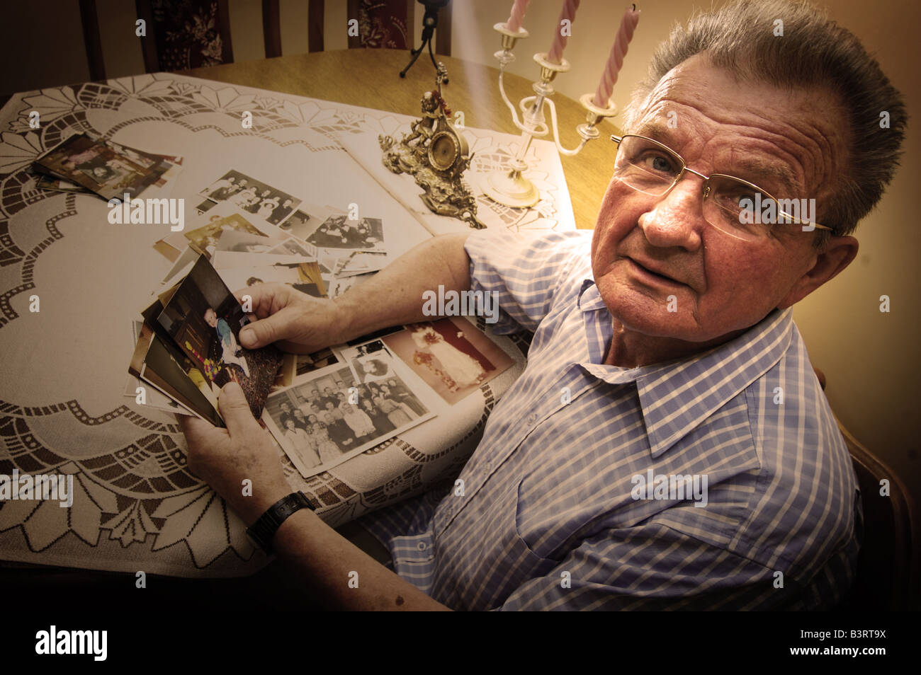 Senior man looking at old photographs. Reminisce about the past Stock Photo