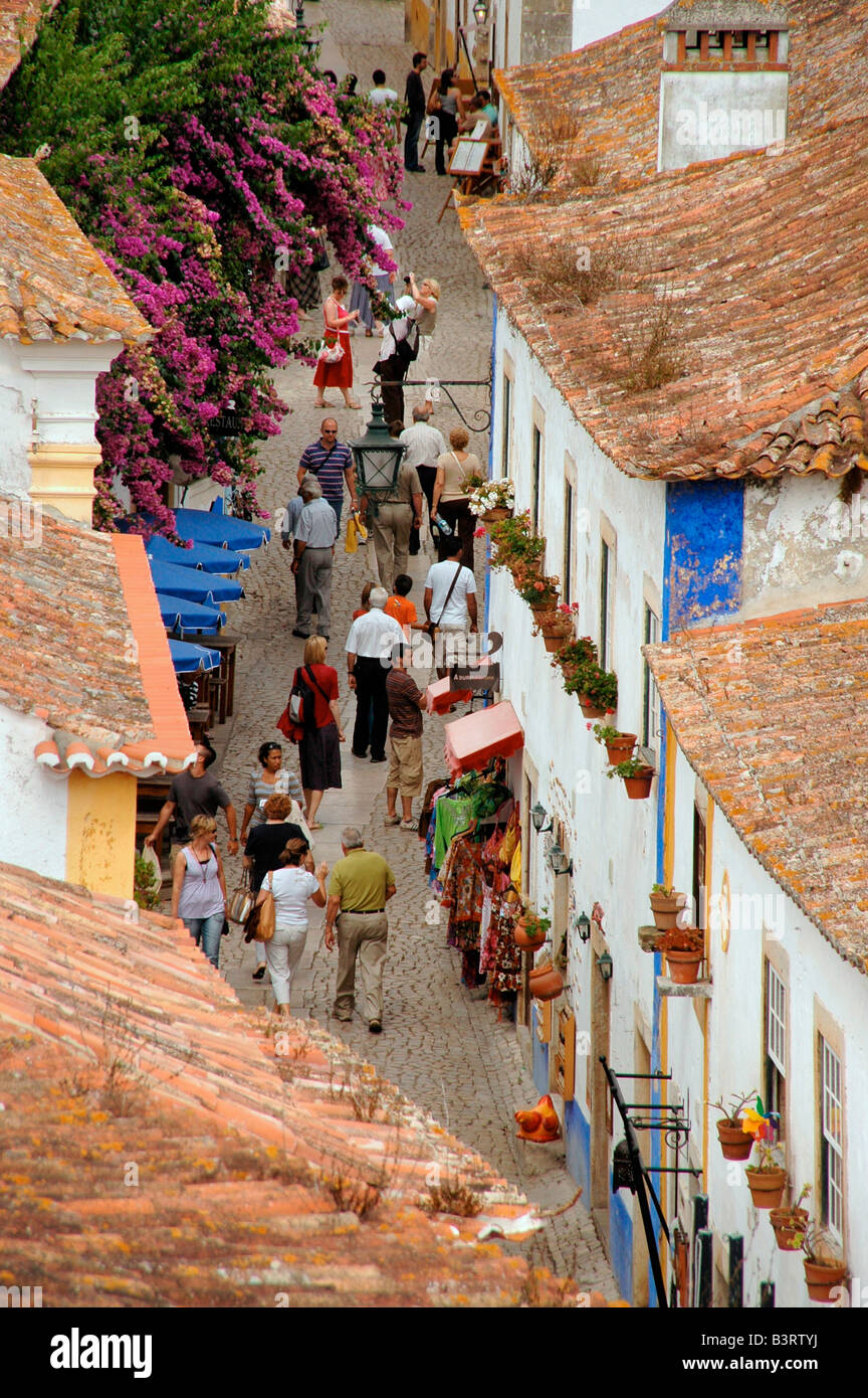 A street scene within the preserved medieval town of Obidos, Portugal. Stock Photo