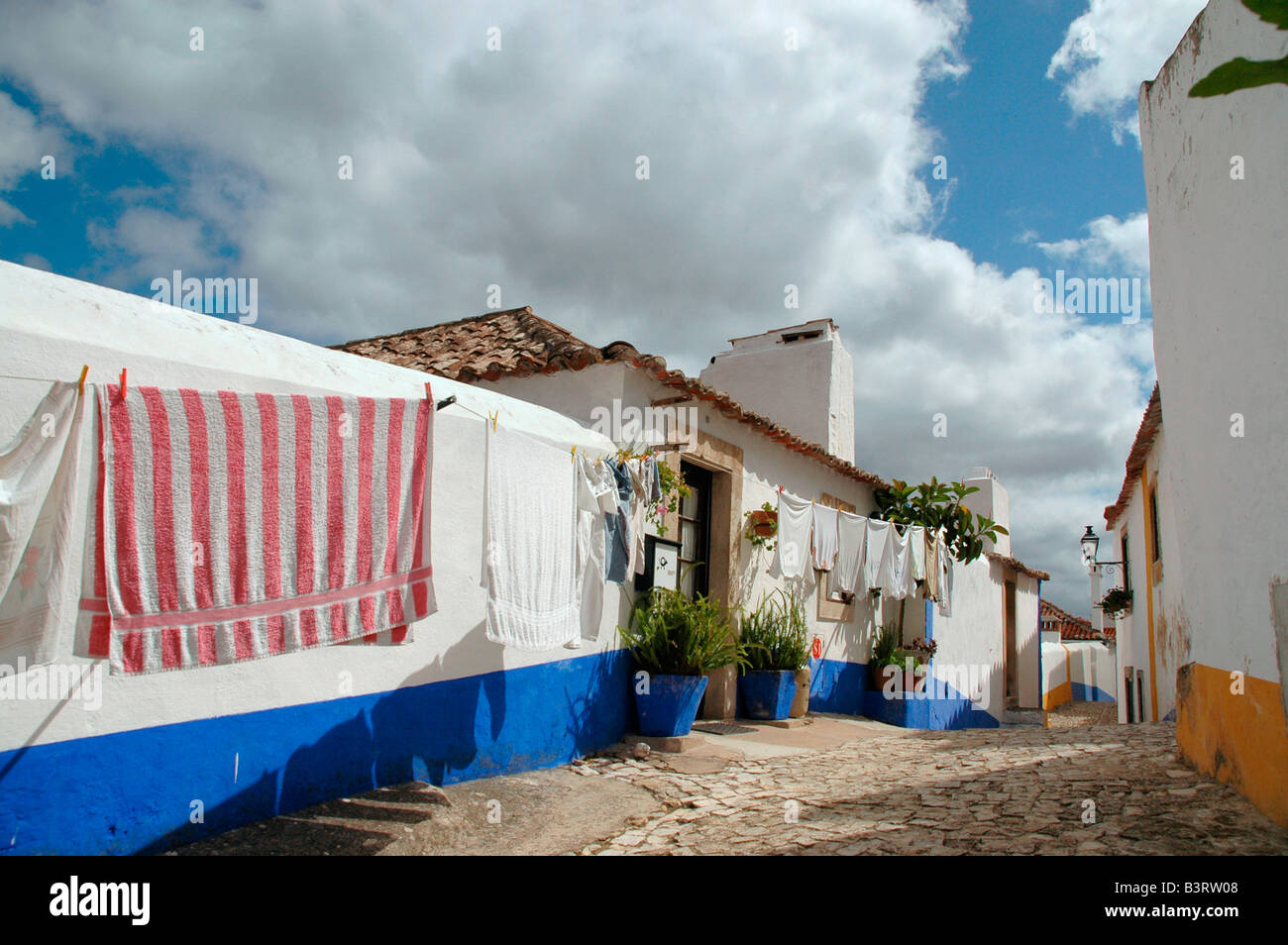 A street scene within the preserved medieval town of Obidos, Portugal. Stock Photo