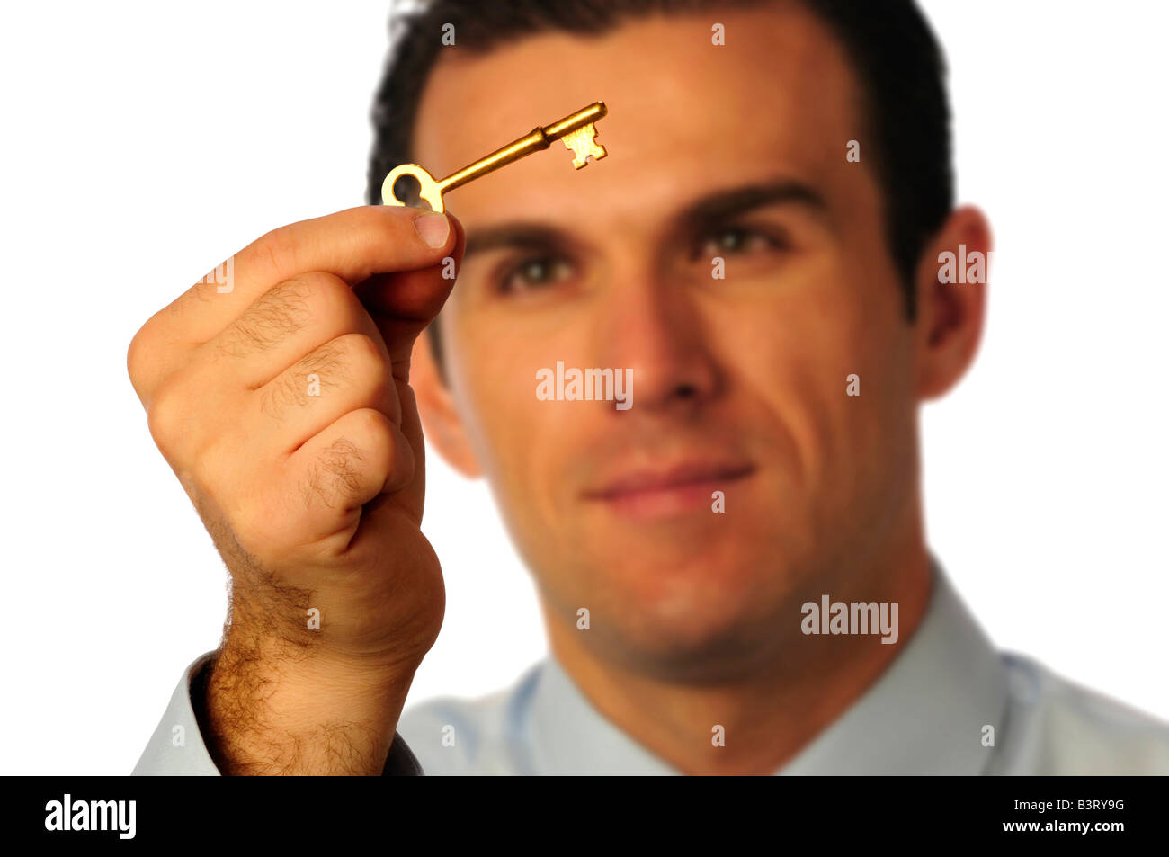 Man looking at gold skeleton key representing opportunity Stock Photo