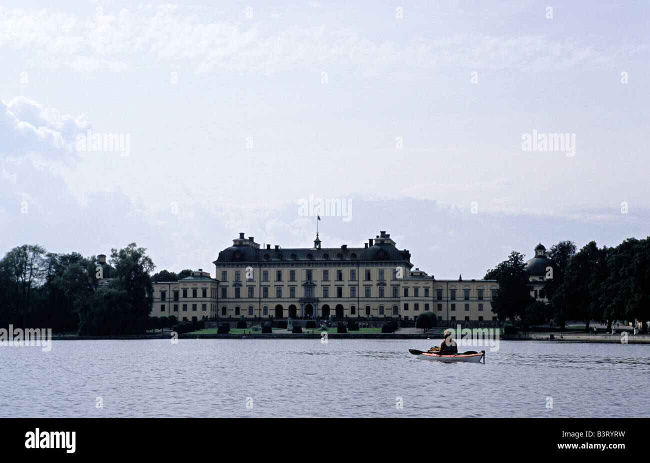 Younger woman kayaking in front of Drottningholm Palace UNESCO World Heritage Stockholms Lan Sweden August 2006 Stock Photo