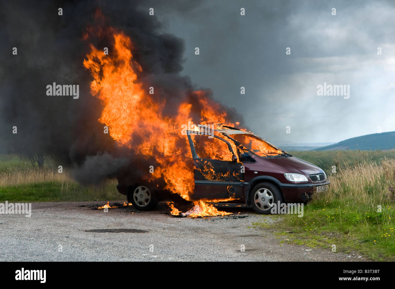 A lucky escape for the driver of this car as it burst into flames on a remote rural road in Scotland. Stock Photo