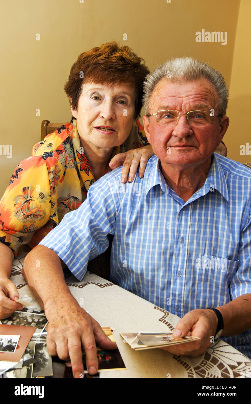 Senior couple looking at old photographs. Reminisce about the past Stock Photo