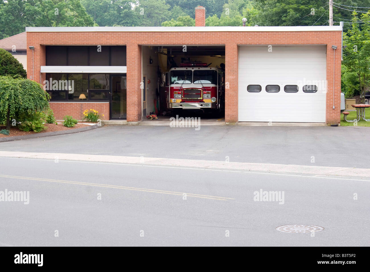 A small fire house with two garage bays Stock Photo