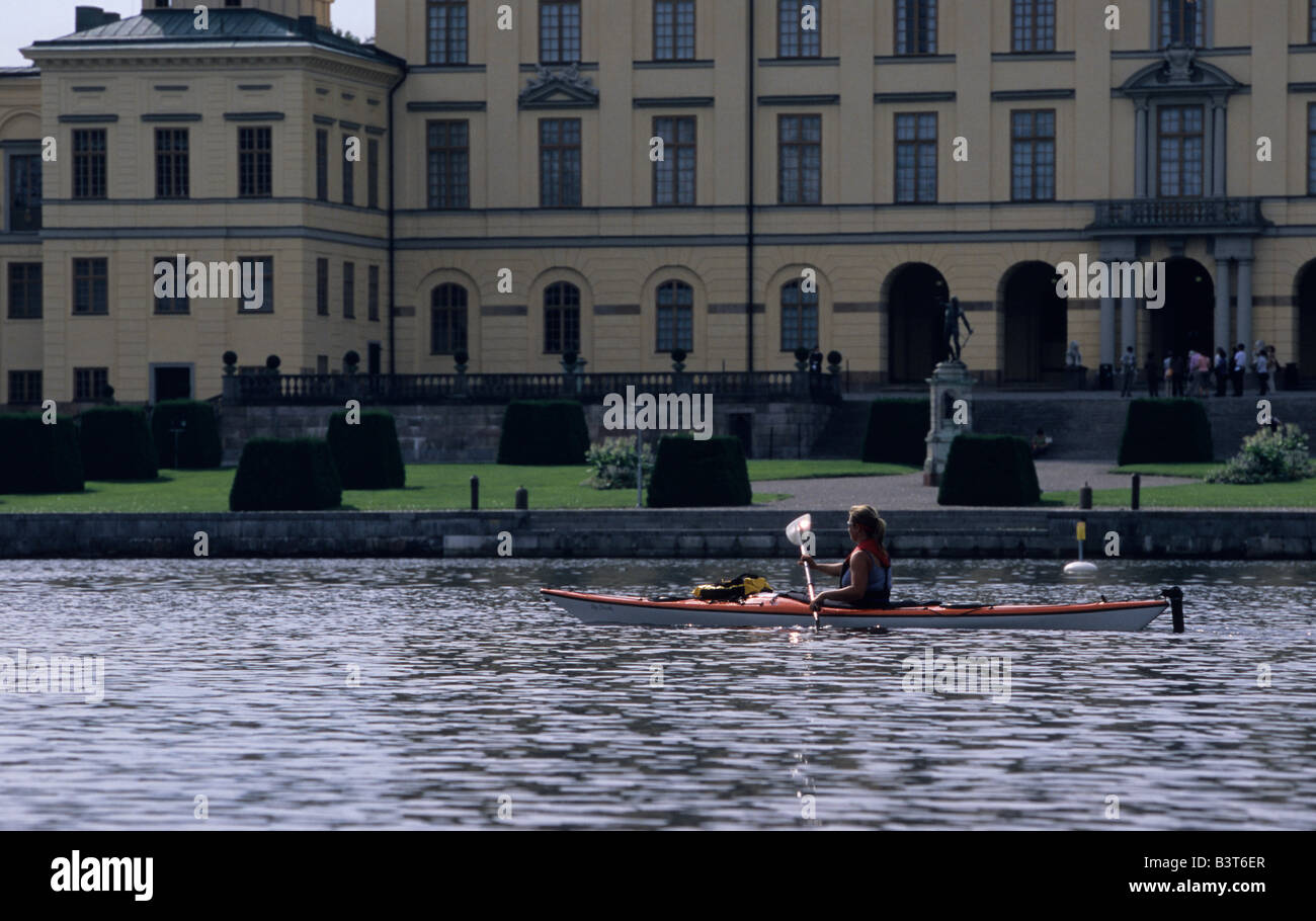 Younger woman kayaking in front of Drottningholm Palace UNESCO World Heritage Stockholms Lan Sweden August 2006 Stock Photo