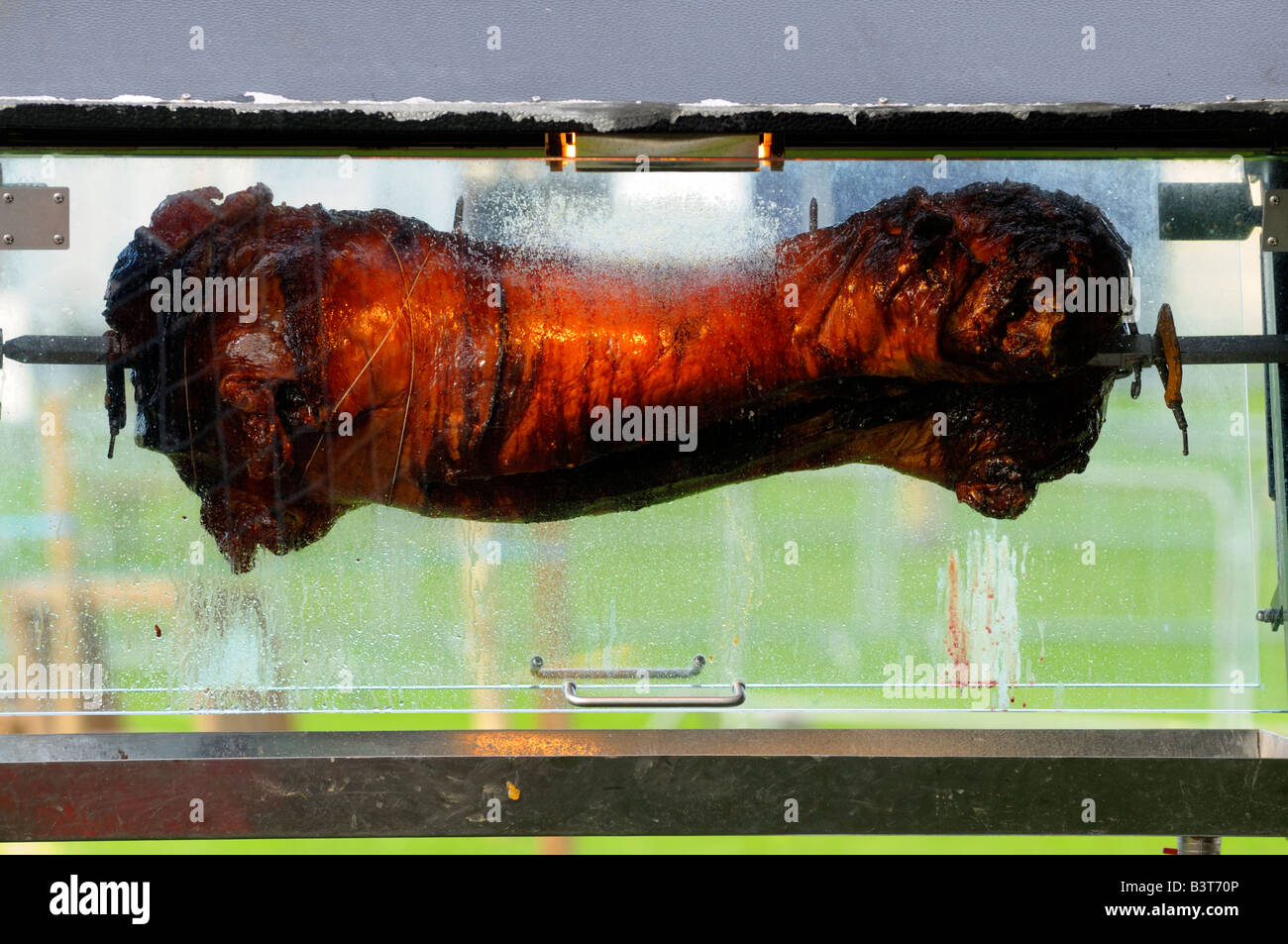 A pig on a spit roast Stock Photo