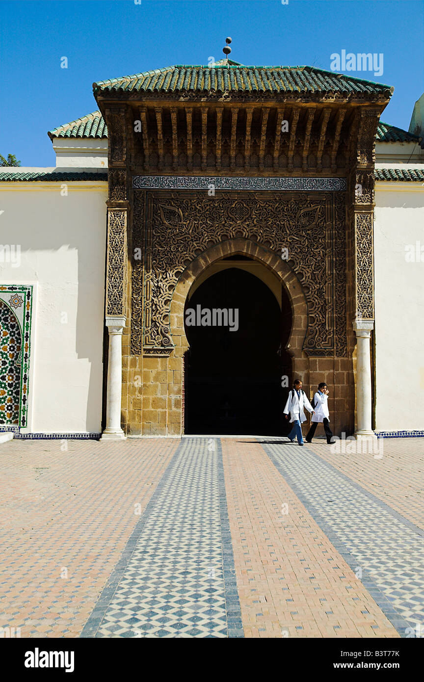 Two children leave through the entrance to the Mausoleum of Moulay Ismail in Meknes, Morocco. Stock Photo