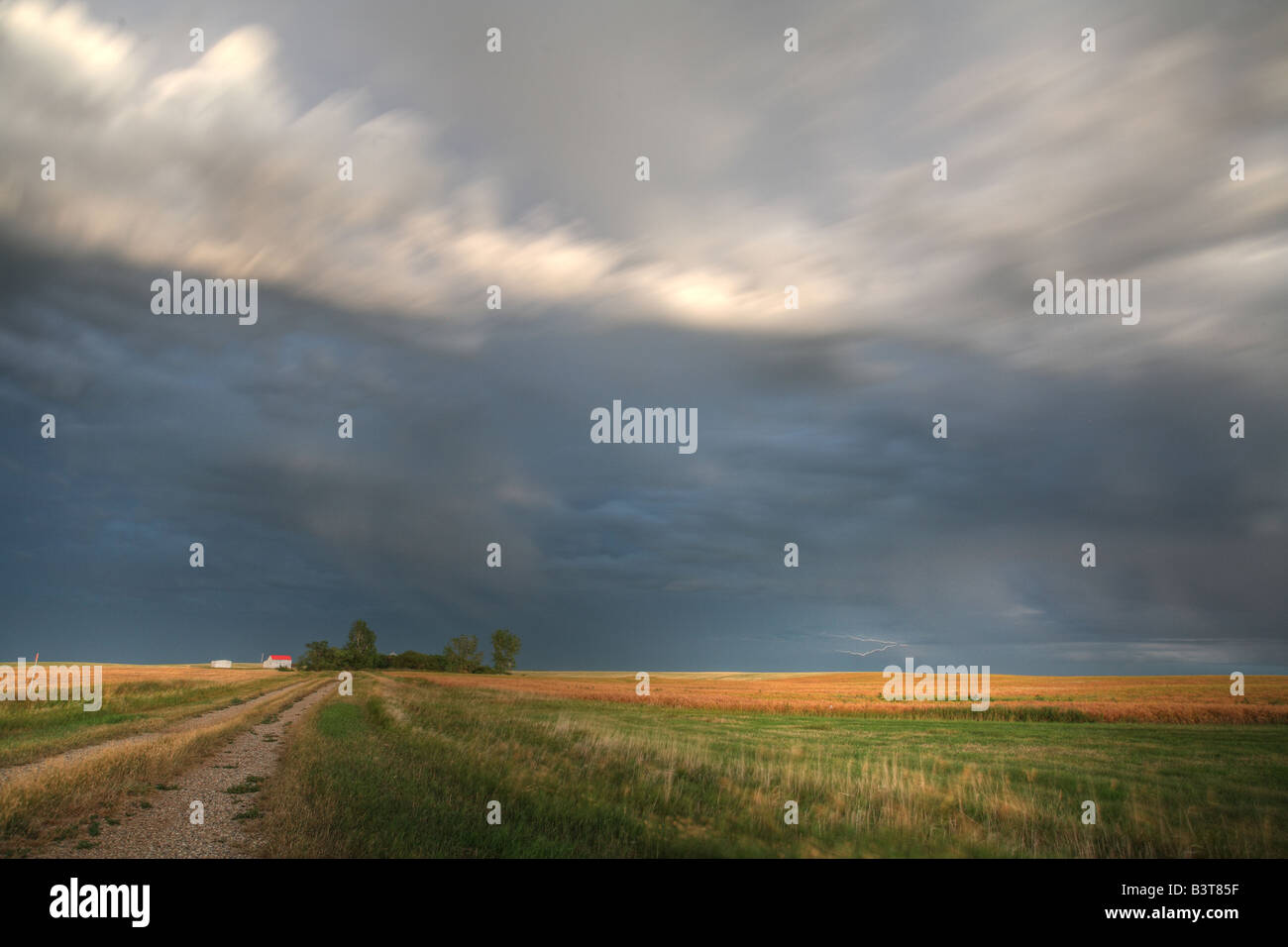 Storm clouds along a Saskatchewan farm road Stock Photo - Alamy