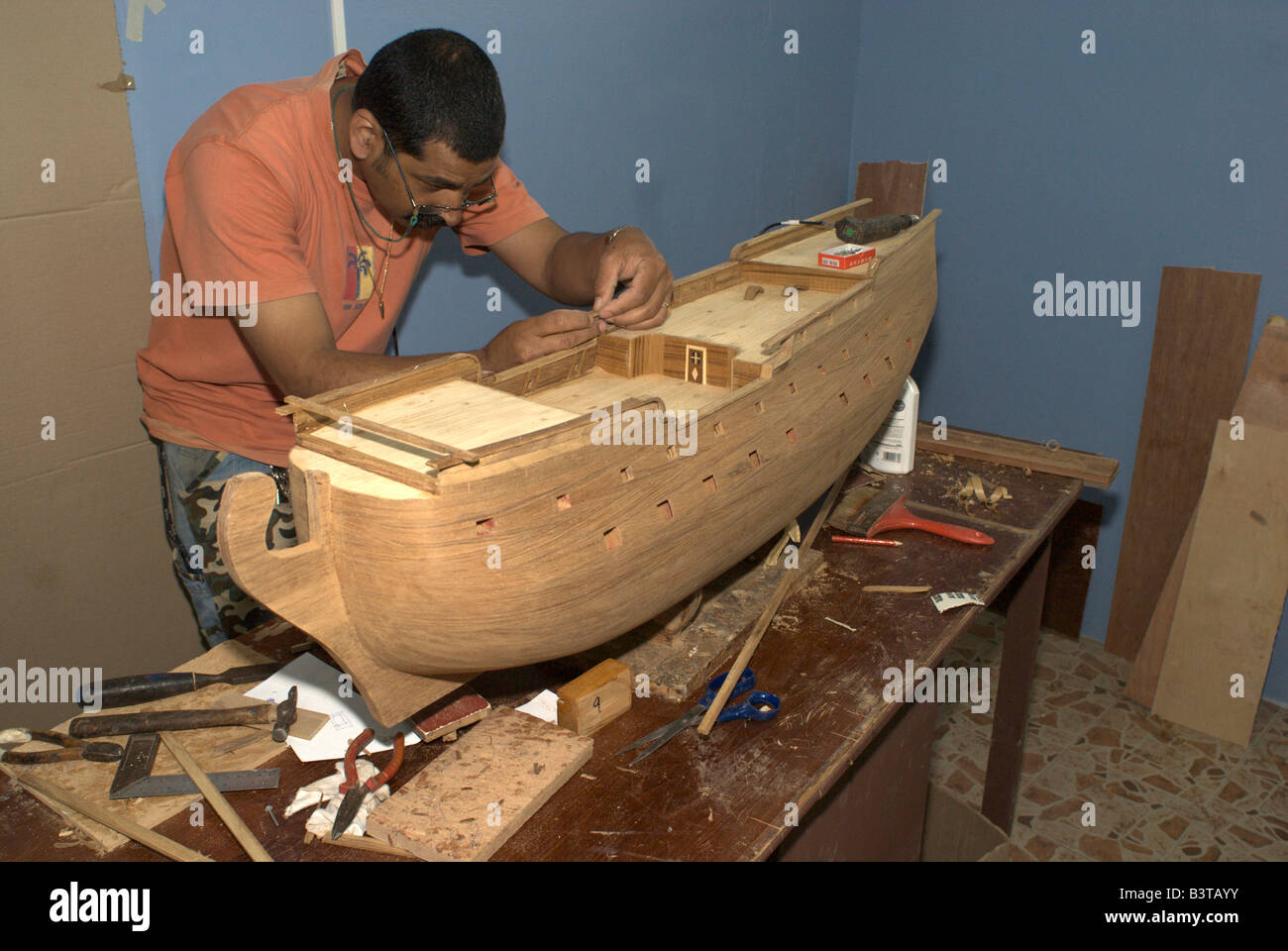 mauritius, curepipe. worker at the comajora model ship