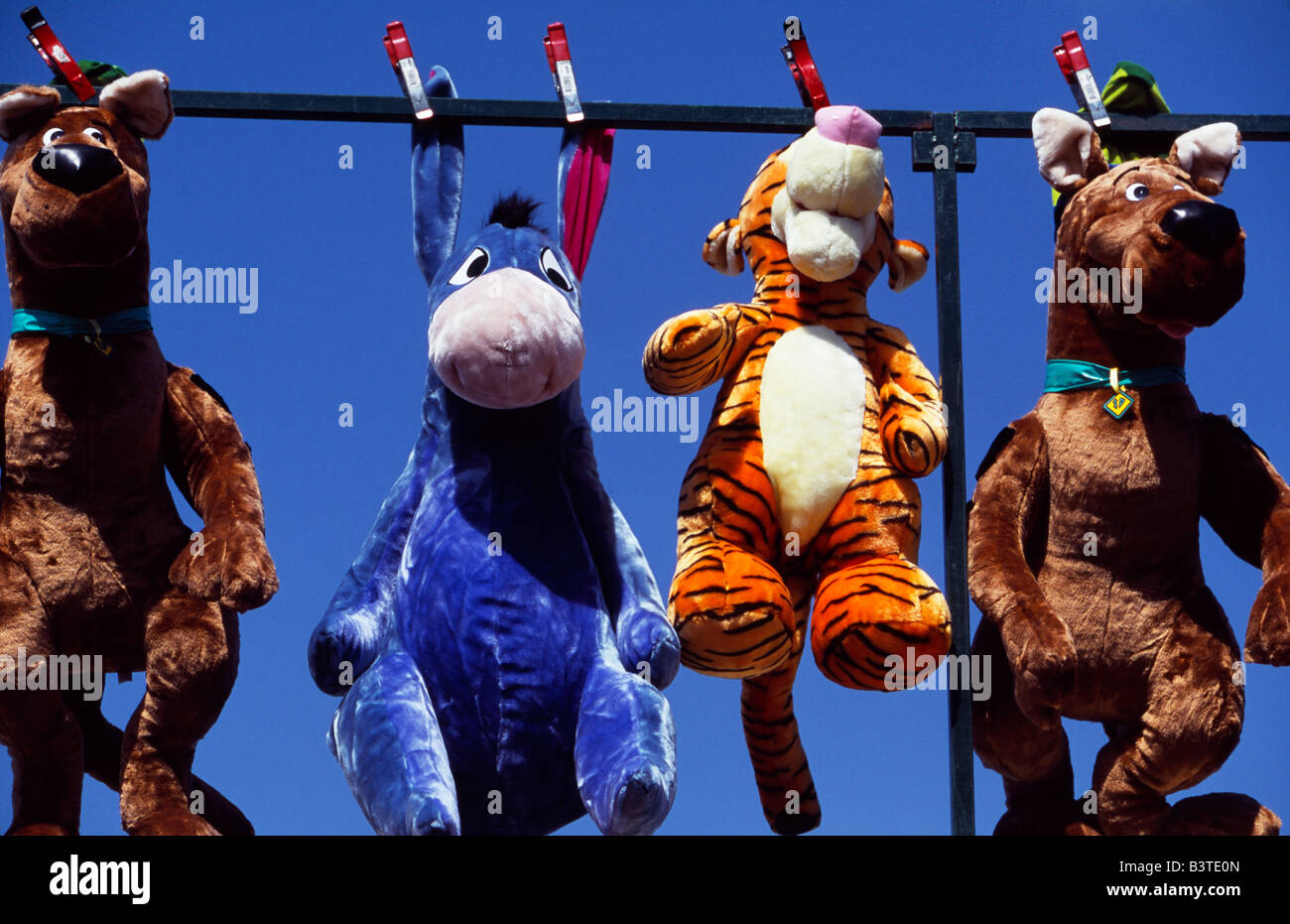 Stuffed cuddly toy characters from Winnie the Pooh displayed as prizes