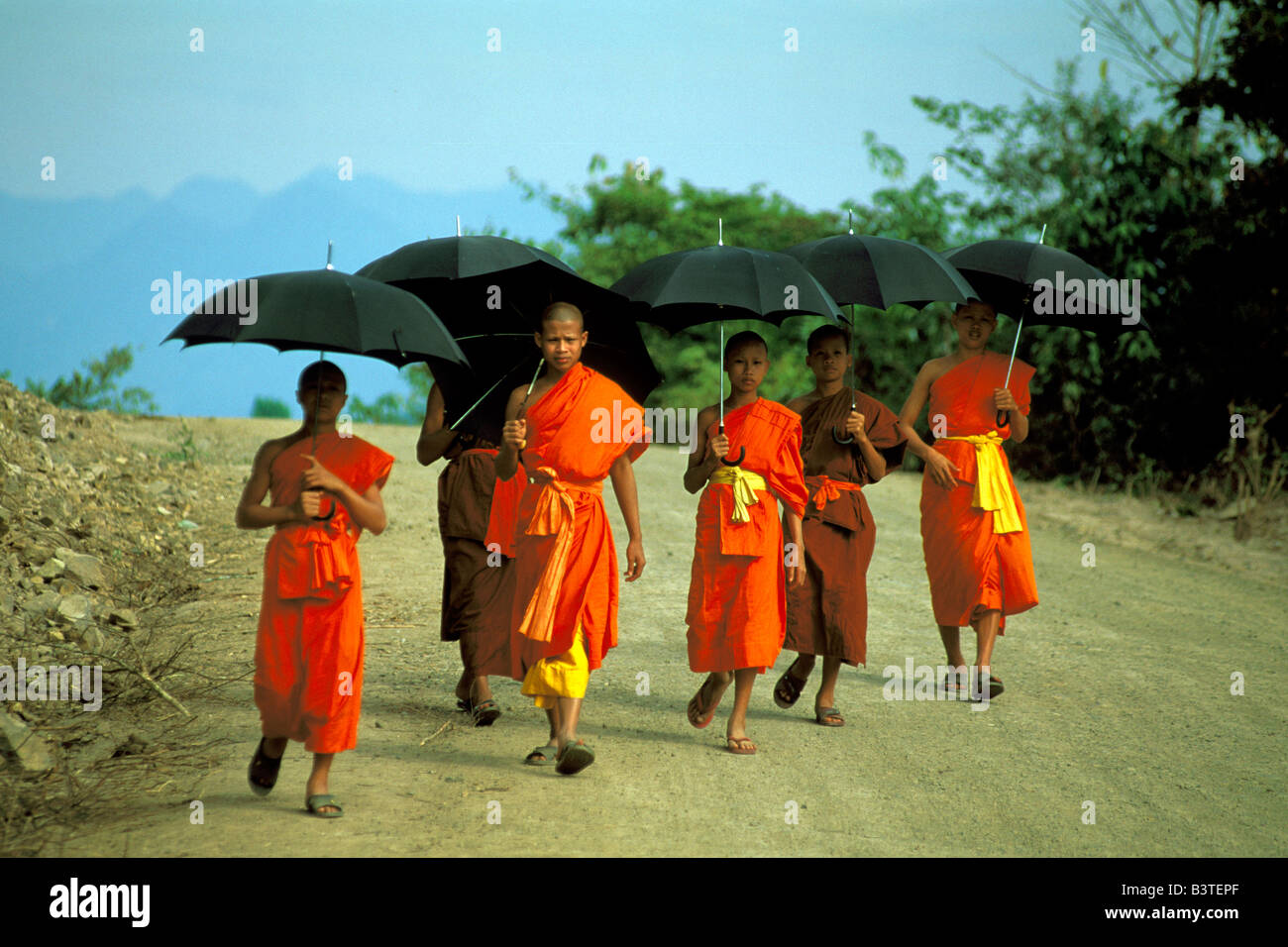 Asia, Laos, Luang Prabang. Monks on a Sunday stroll. Stock Photo