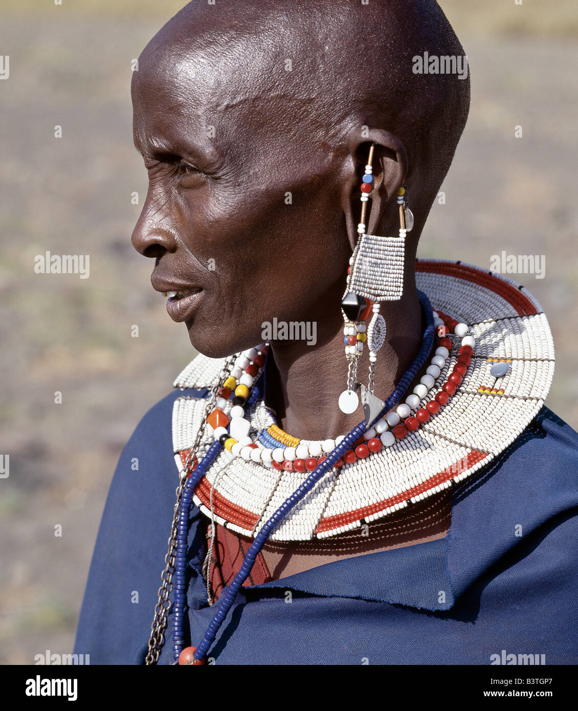 Tanzania, Northern Tanzania, Engaruka. A Maasai woman in traditional attire. The preponderance of white glass beads in her ornaments denotes that she is from the Kisongo section of the Maasai, the largest clan group, which lives on both sides of the Kenya-Tanzania border. Stock Photo