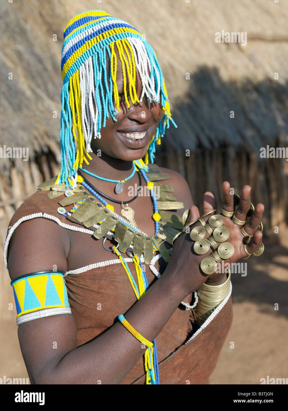 Tanzania, Northern Tanzania, Balangida Lelu. A Datoga woman with a beaded hat worn on ceremonial occasions. The traditional attire of Datoga women includes beautifully tanned and decorated leather dresses and coiled brass armbands, necklaces and rings. Yellow and light blue are the preferred colours of the beads they wear. Scarification of the face is not uncommon among women and girls.The Datoga (known to their Maasai neighbours as the Mang'ati and to the Iraqw as Babaraig) live in northern Tanzania and are primarily pastoralists. Stock Photo