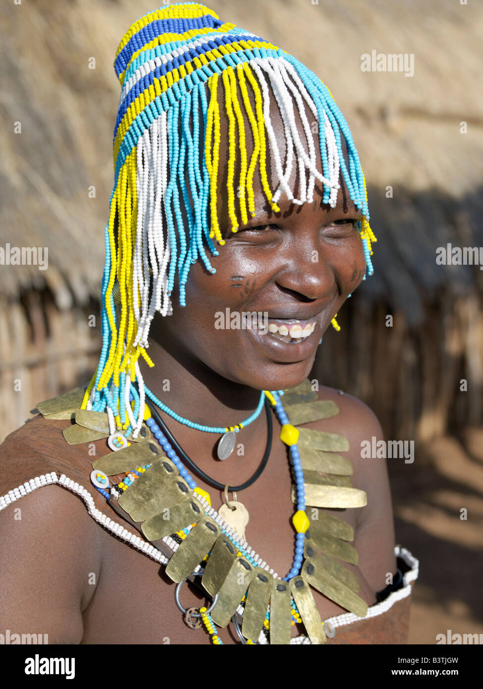 Tanzania, Northern Tanzania, Balangida Lelu. A Datoga woman with a beaded hat worn on ceremonial occasions. The traditional attire of Datoga women includes beautifully tanned and decorated leather dresses and coiled brass armbands and necklaces. Yellow and light blue are the preferred colours of the beads they wear. Scarification of the face is not uncommon among women and girls.The Datoga (known to their Maasai neighbours as the Mang'ati and to the Iraqw as Babaraig) live in northern Tanzania and are primarily pastoralists. Stock Photo