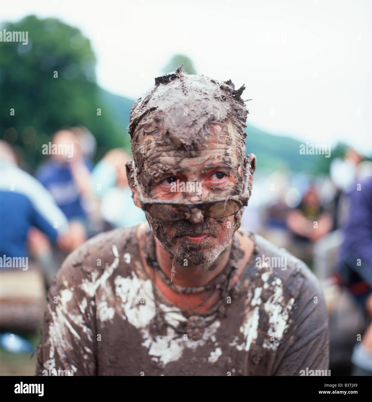 A man covered in mud at the Green Man Festival at Glanusk near Crickhowell Wales UK  KATHY  DEWITT Stock Photo