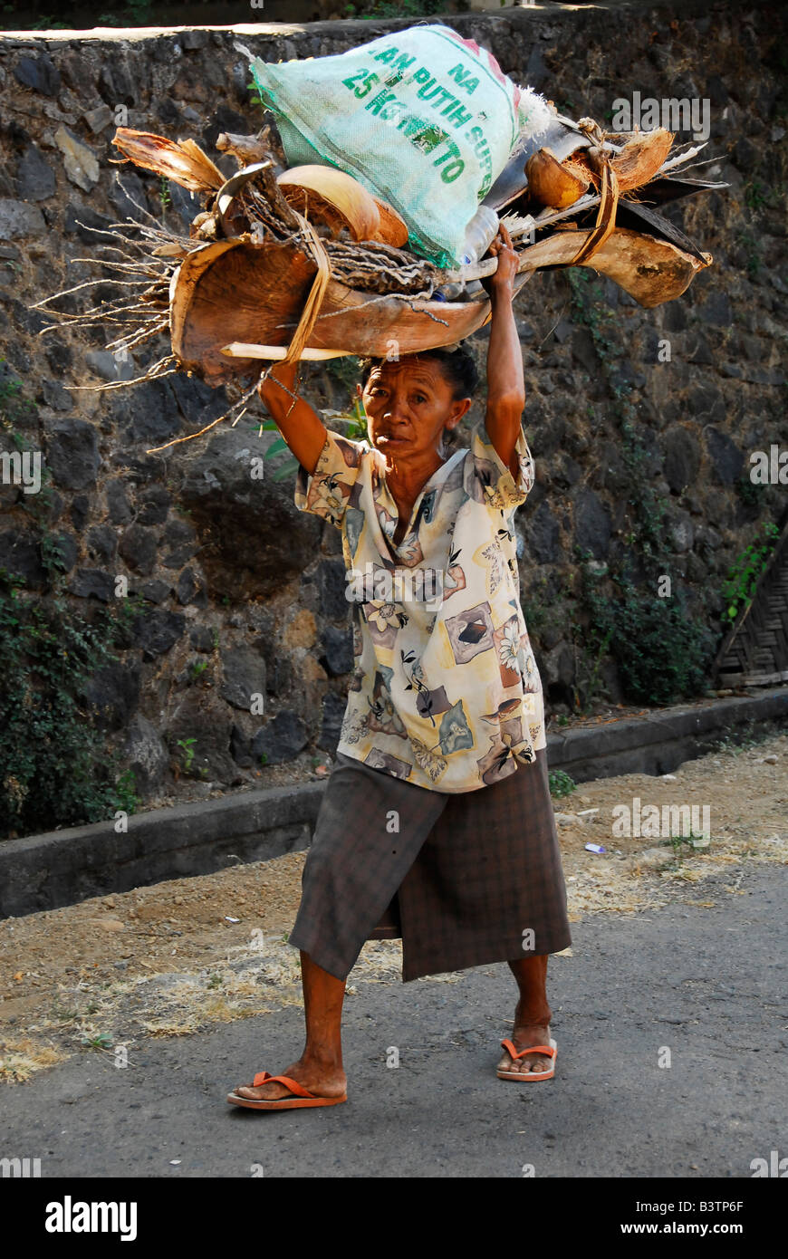 bali aga village life , women carrying goods on her head , julah, bali aga village , north bali , indonesia Stock Photo
