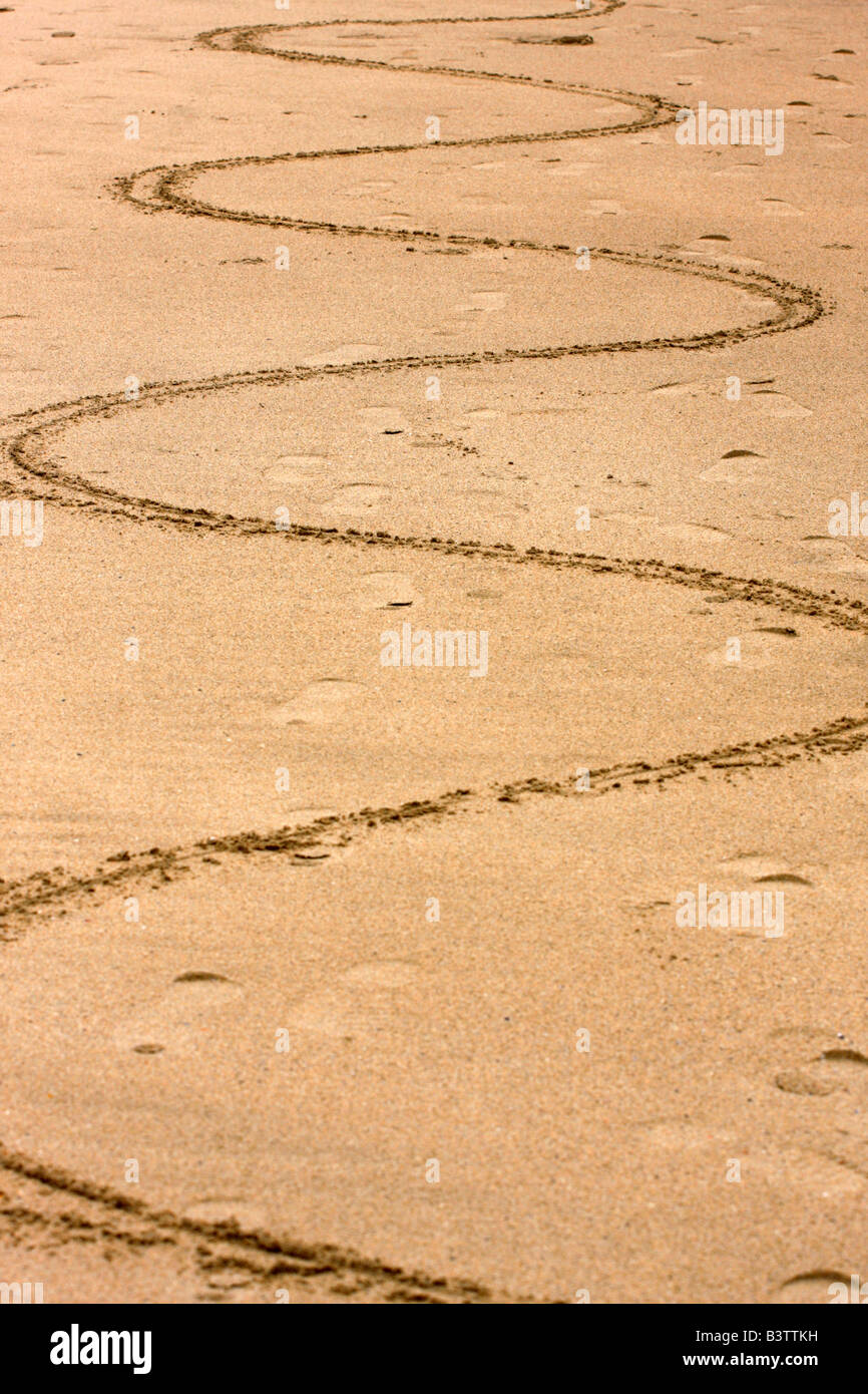 wavy line scored into the sand on a beach Stock Photo