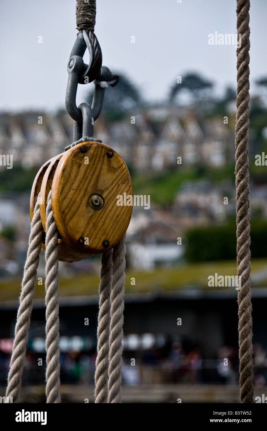 Rope and a wooden pulley block in Newlyn Harbour Cornwall. Stock Photo