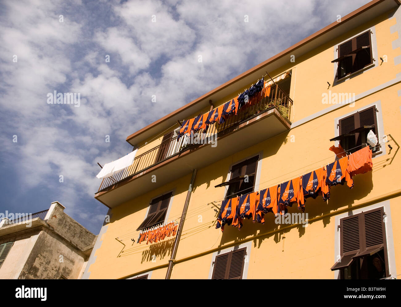 Europe, Italy, Cinque Terre, Riomaggiore. A sport team's uniforms hanging out to dry. Stock Photo