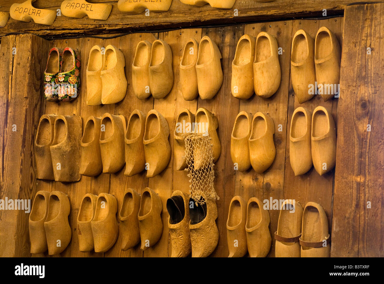 Netherlands (aka Holland), Zaandam. Zaanse Schans, Wooden Shoe Museum, styles of clogs on wall display. Stock Photo