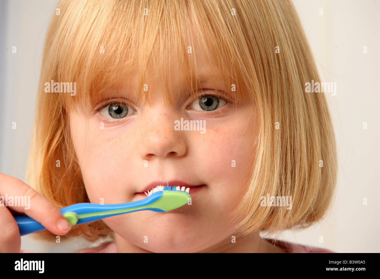 A young girl cleaning her teeth Stock Photo