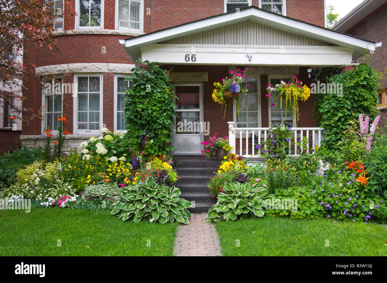 A Wolseley area home front yard and boulevard planted with spring flowers in Winnipeg, Manitoba