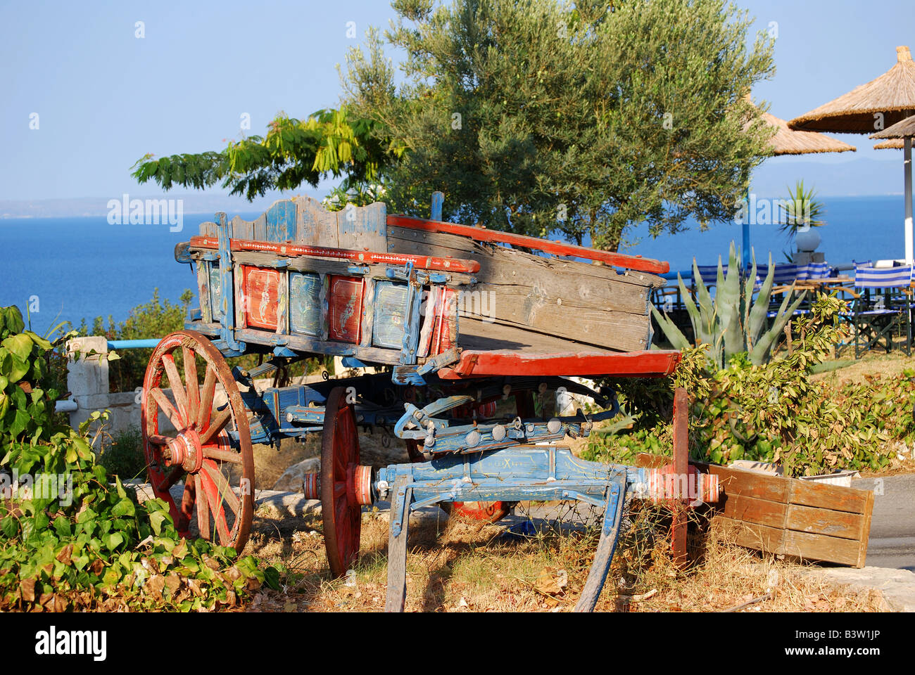 Old wooden wagon by restaurant, Kallithea, Kassandra Peninsula, Chalkidiki, Central Macedonia, Greece Stock Photo