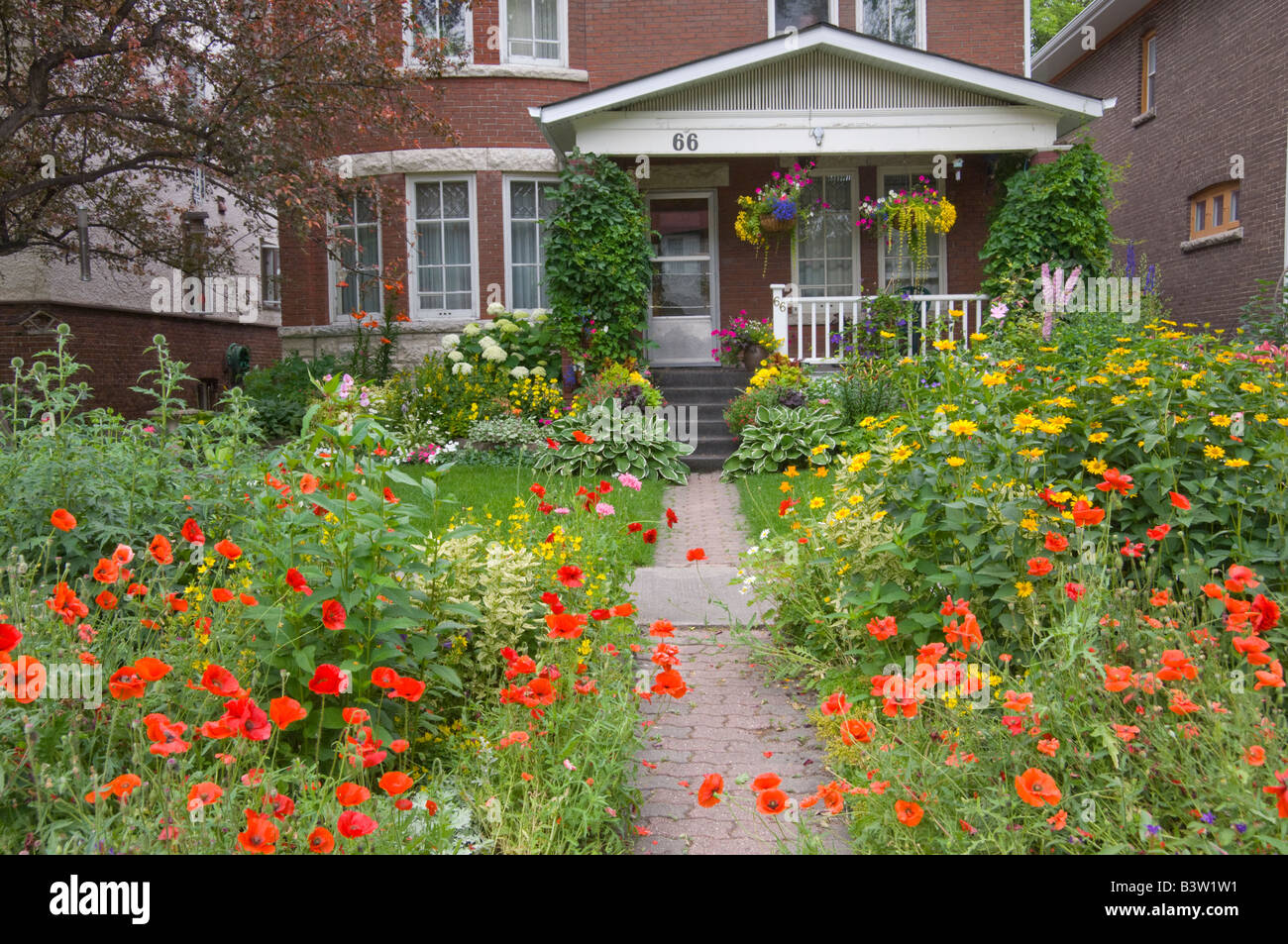 Wolseley area home with decorative spring flowers in the front yard and on the boulevards in