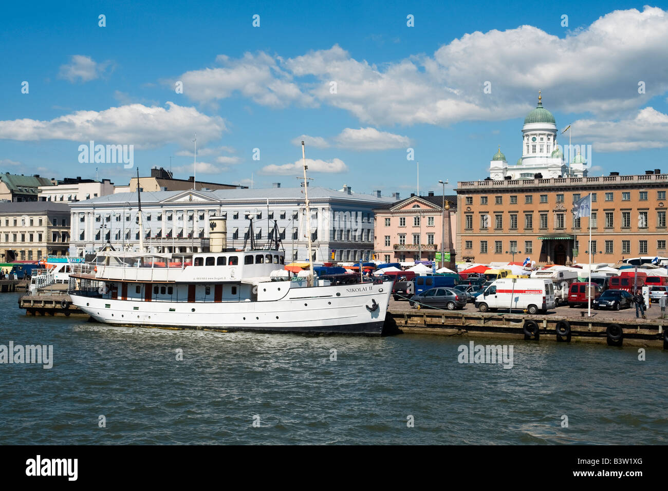 View of Helsinki market square, Kauppatori, from Helsinki South Harbour.  Historic former steamship, Nikolai II (1903), is docked. Stock Photo