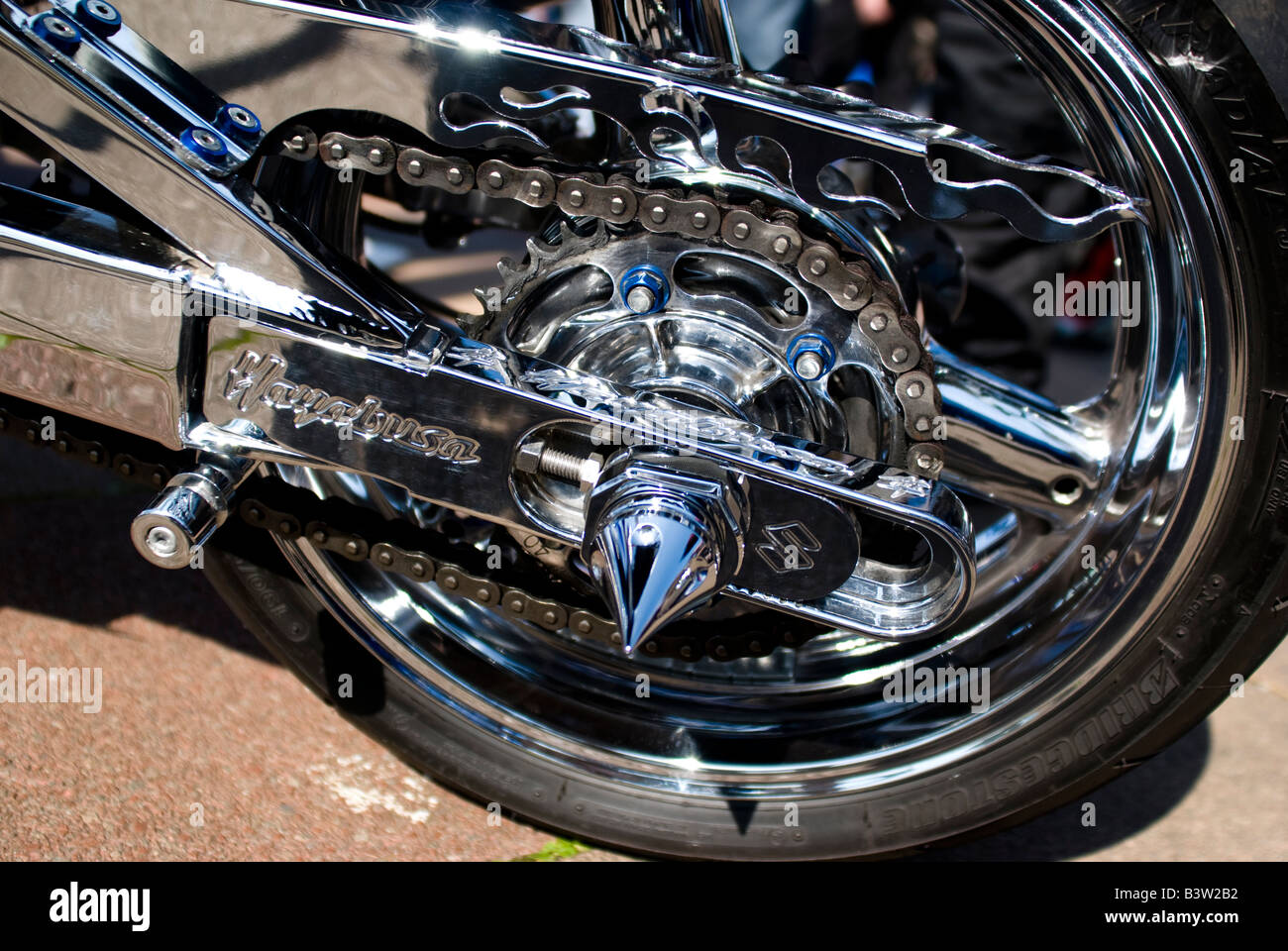 Rear wheel of a motorcycle with chrome work and chain Stock Photo