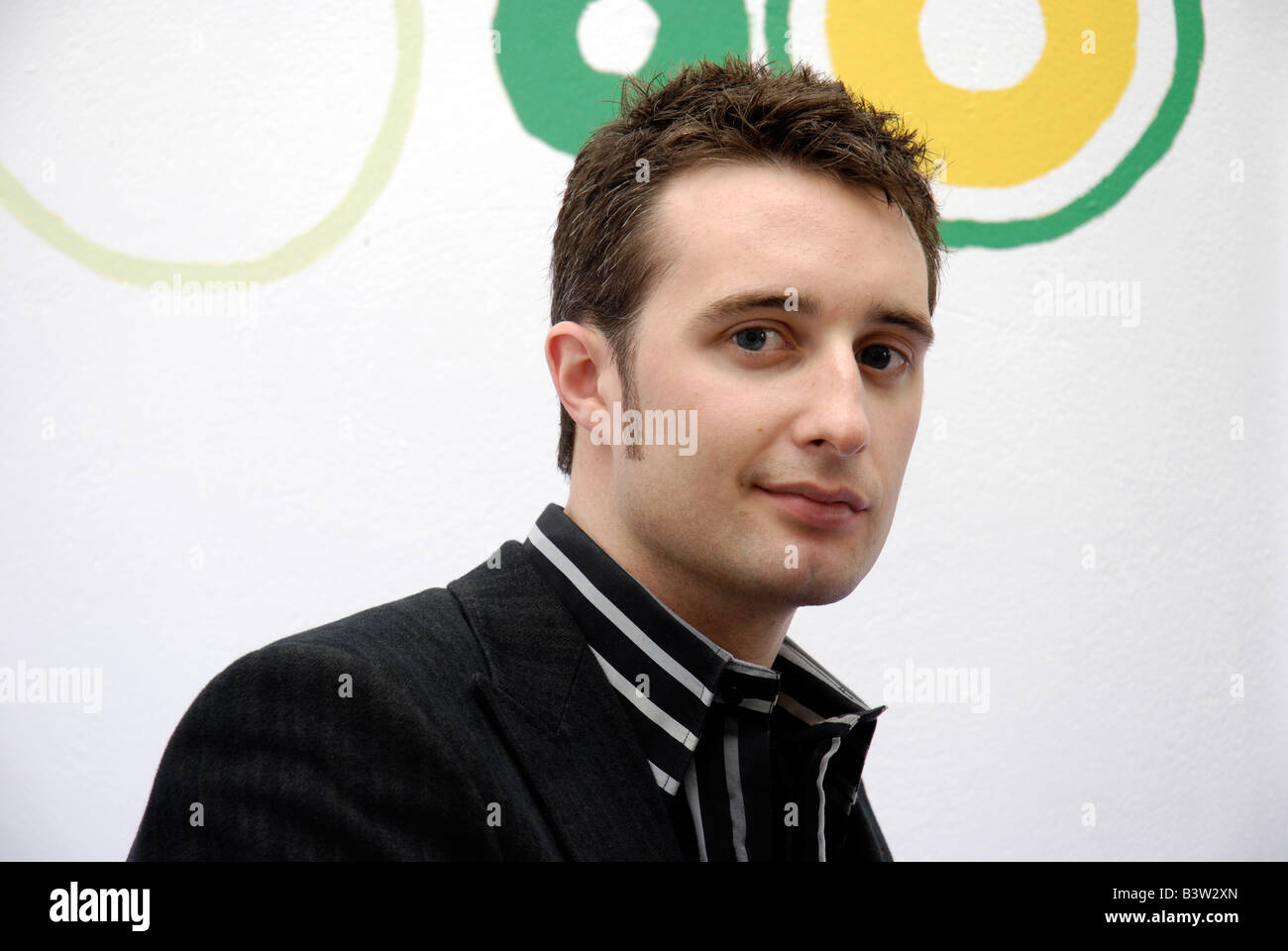 Handsome young businessman in a funky modern office interior Stock Photo