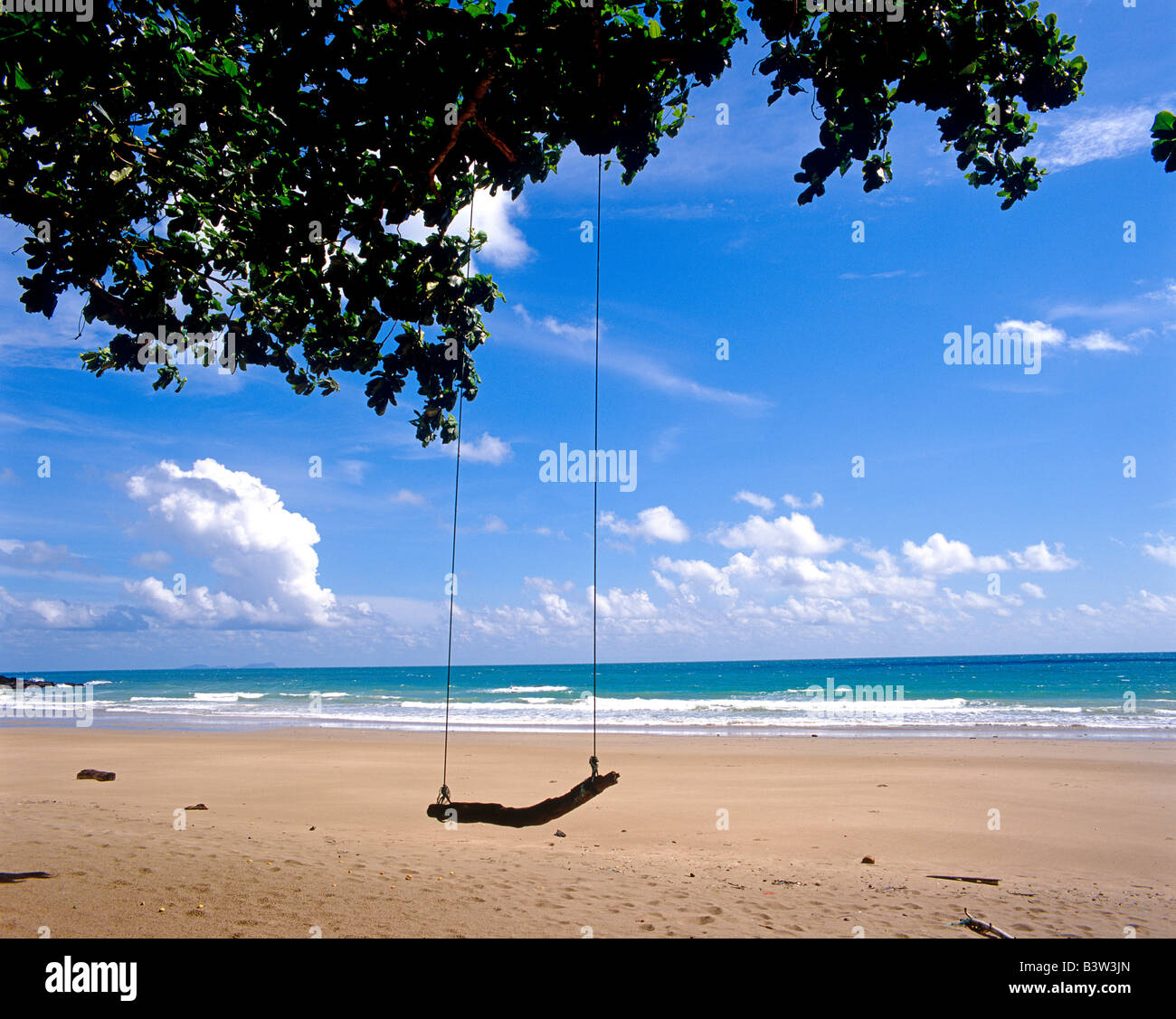 scenic view of sea, sand and swing Blick aufs Meer mit Strand und Schaukel Stock Photo