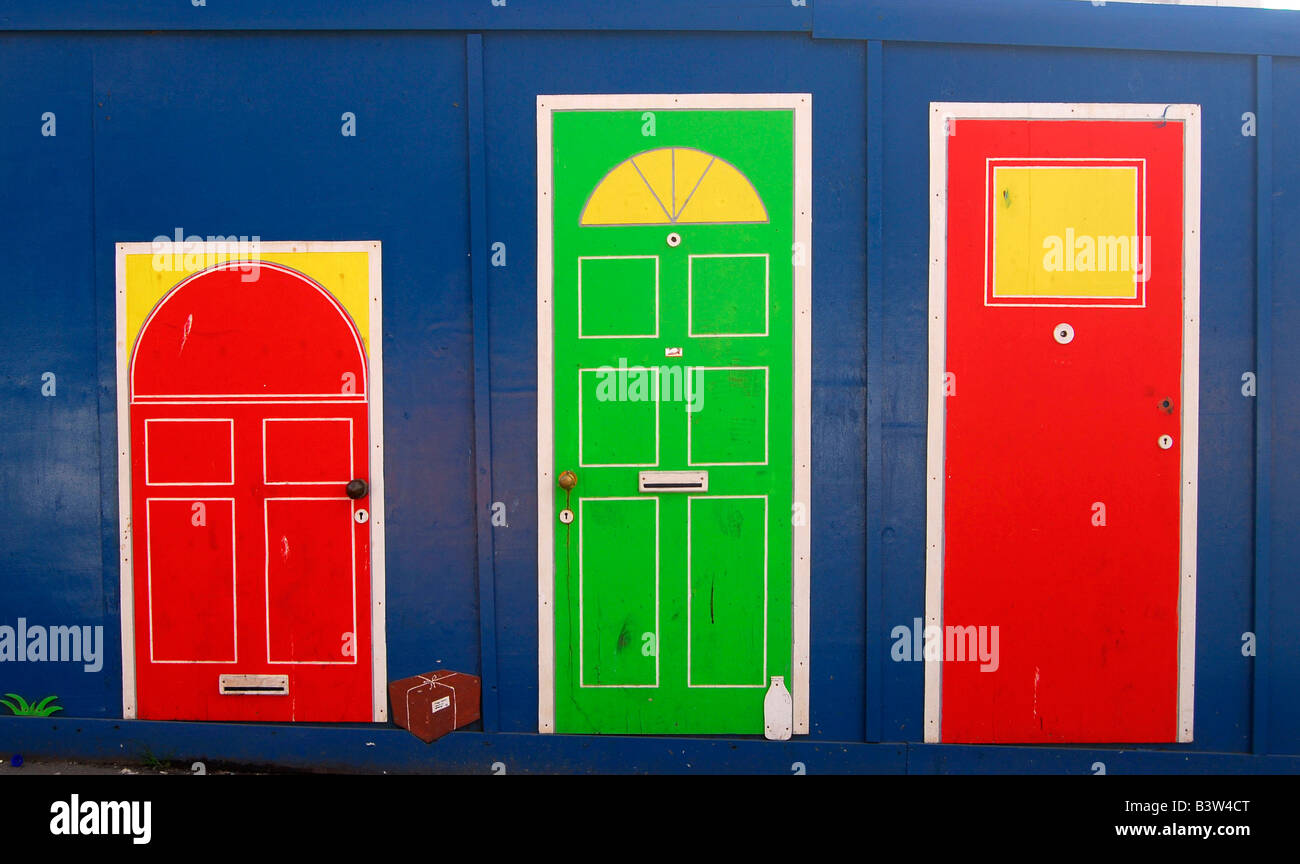 painted doors on a hoarding Stock Photo