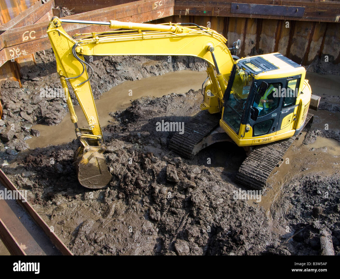 A small excavator moves earth on a construction site Stock Photo Alamy