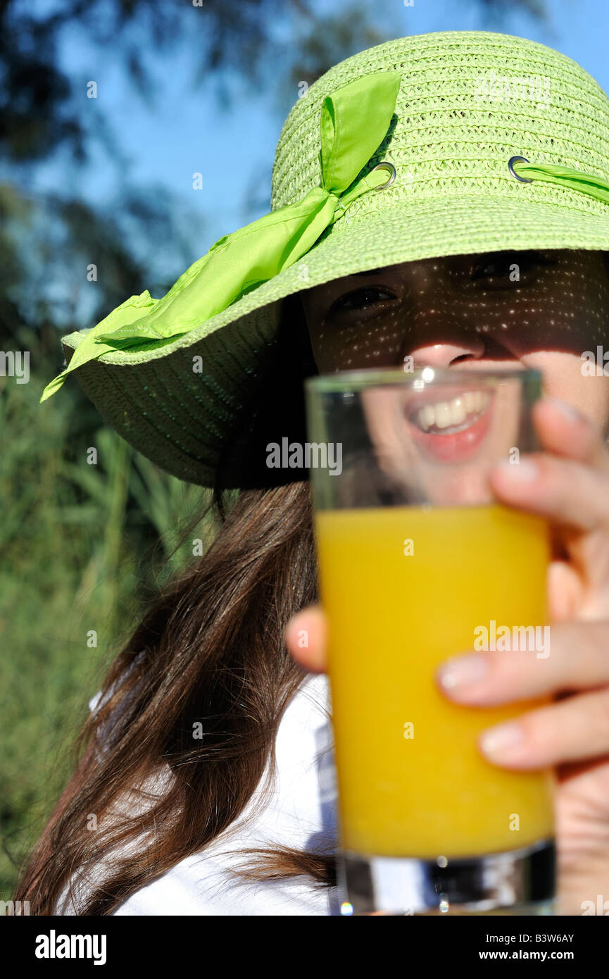 Woman enjoying her summer holiday drinking an orange juice in France