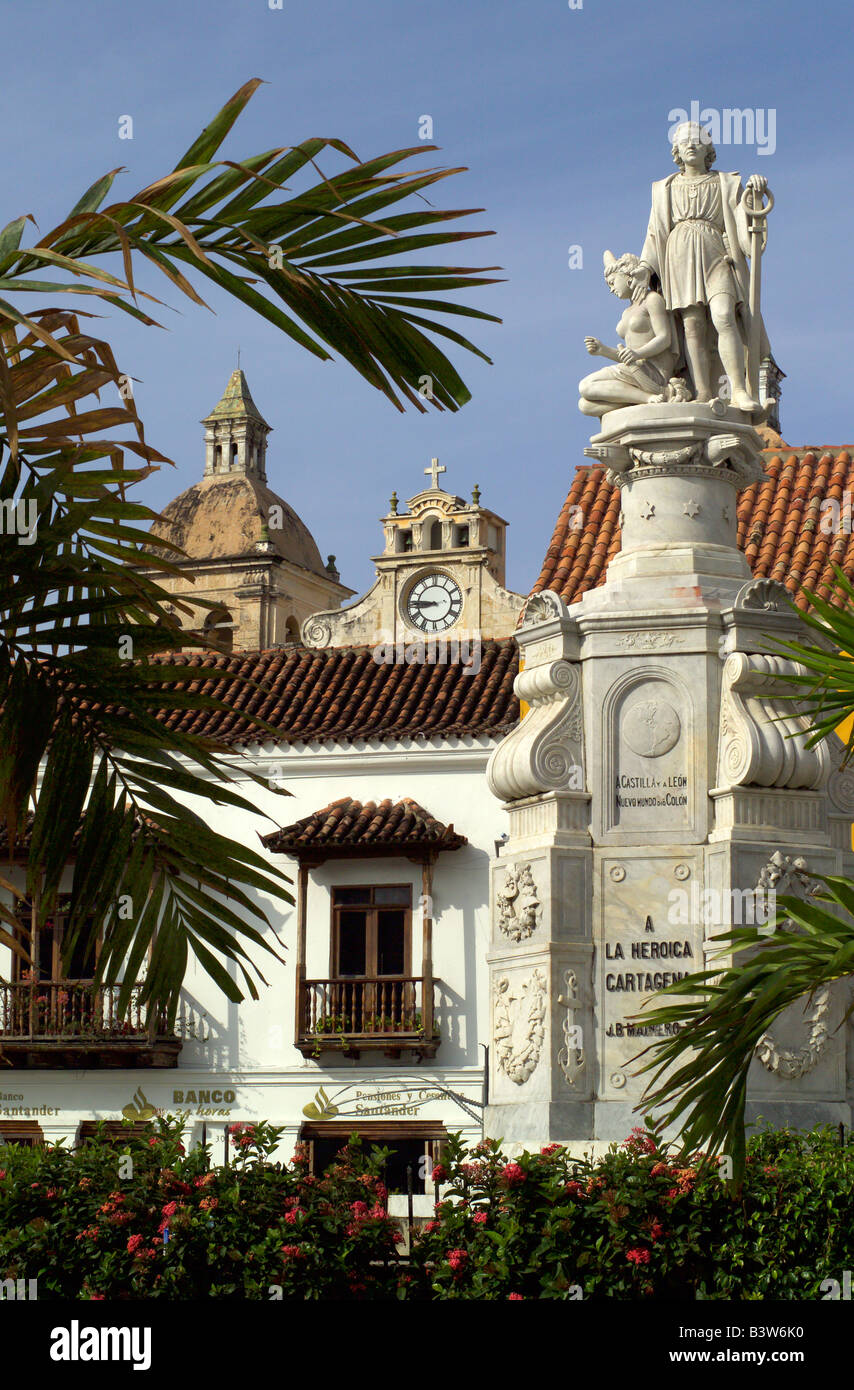 A statue of Christopher Colombus with Spanish colonial buildings behind