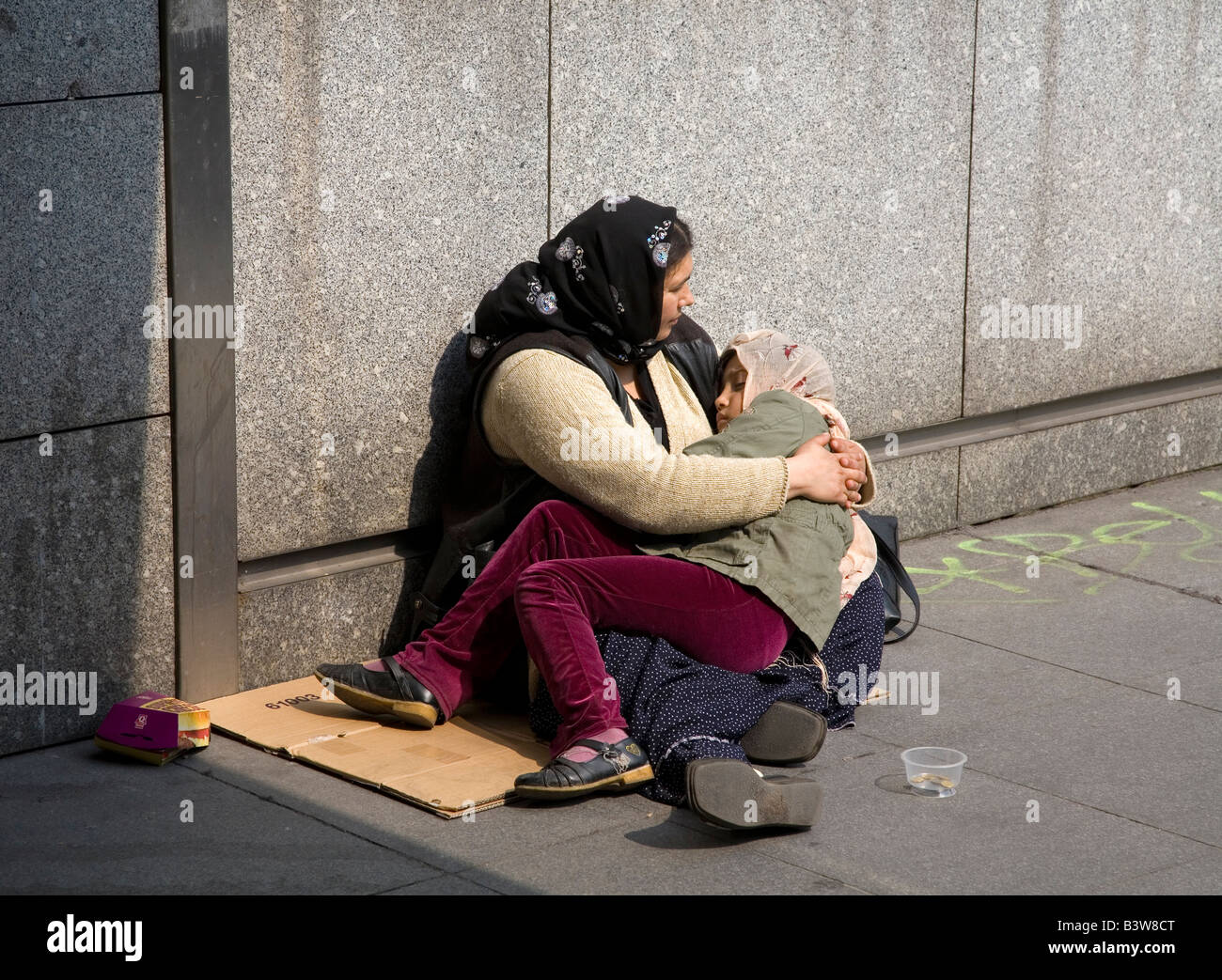 Beggars mother and daughter beg on streets in Paris France Europe EU Stock Photo