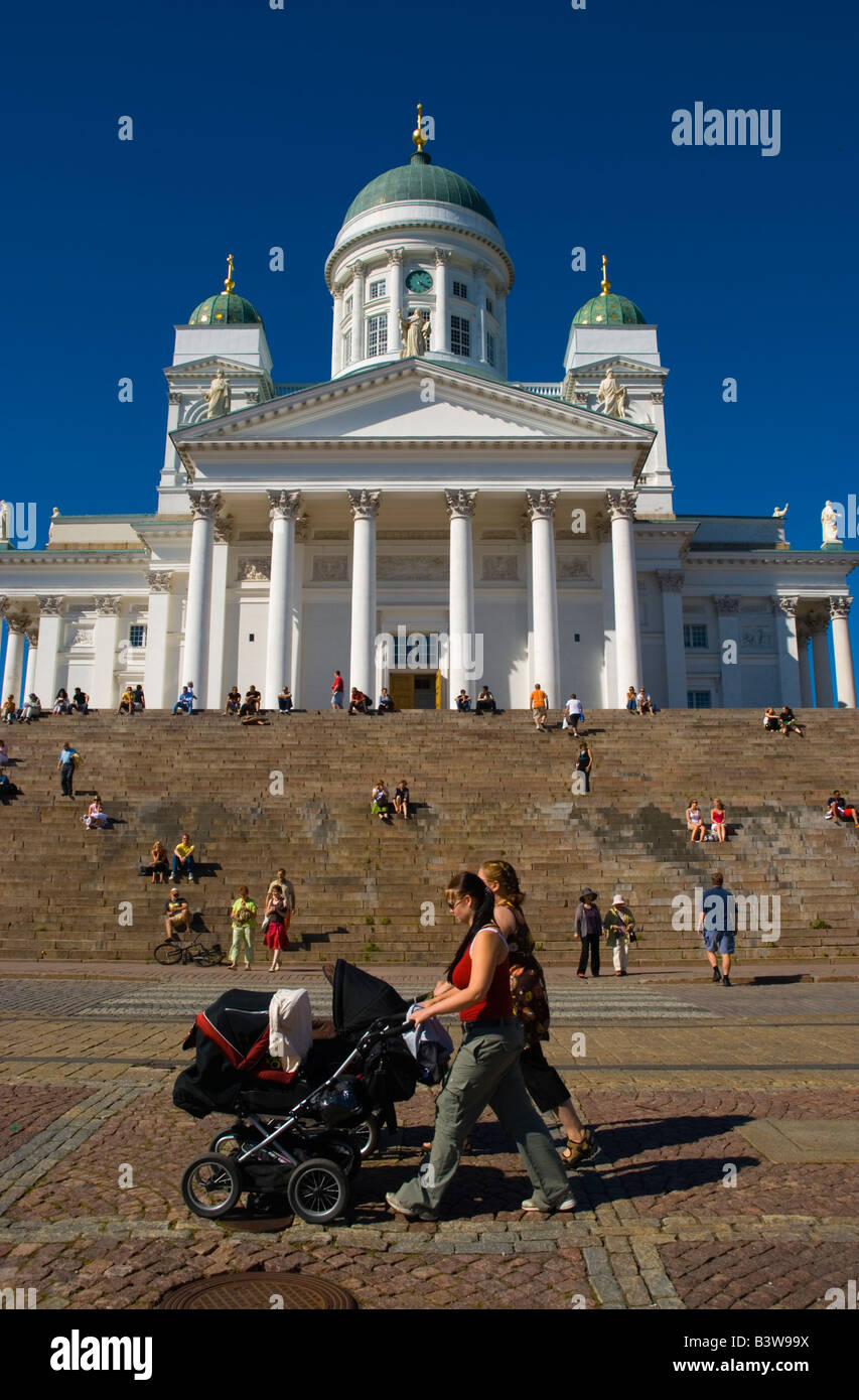 Women Pushing Prams Past Tuomiokirkko Cathedral At Senaatintori Square In Helsinki Finland