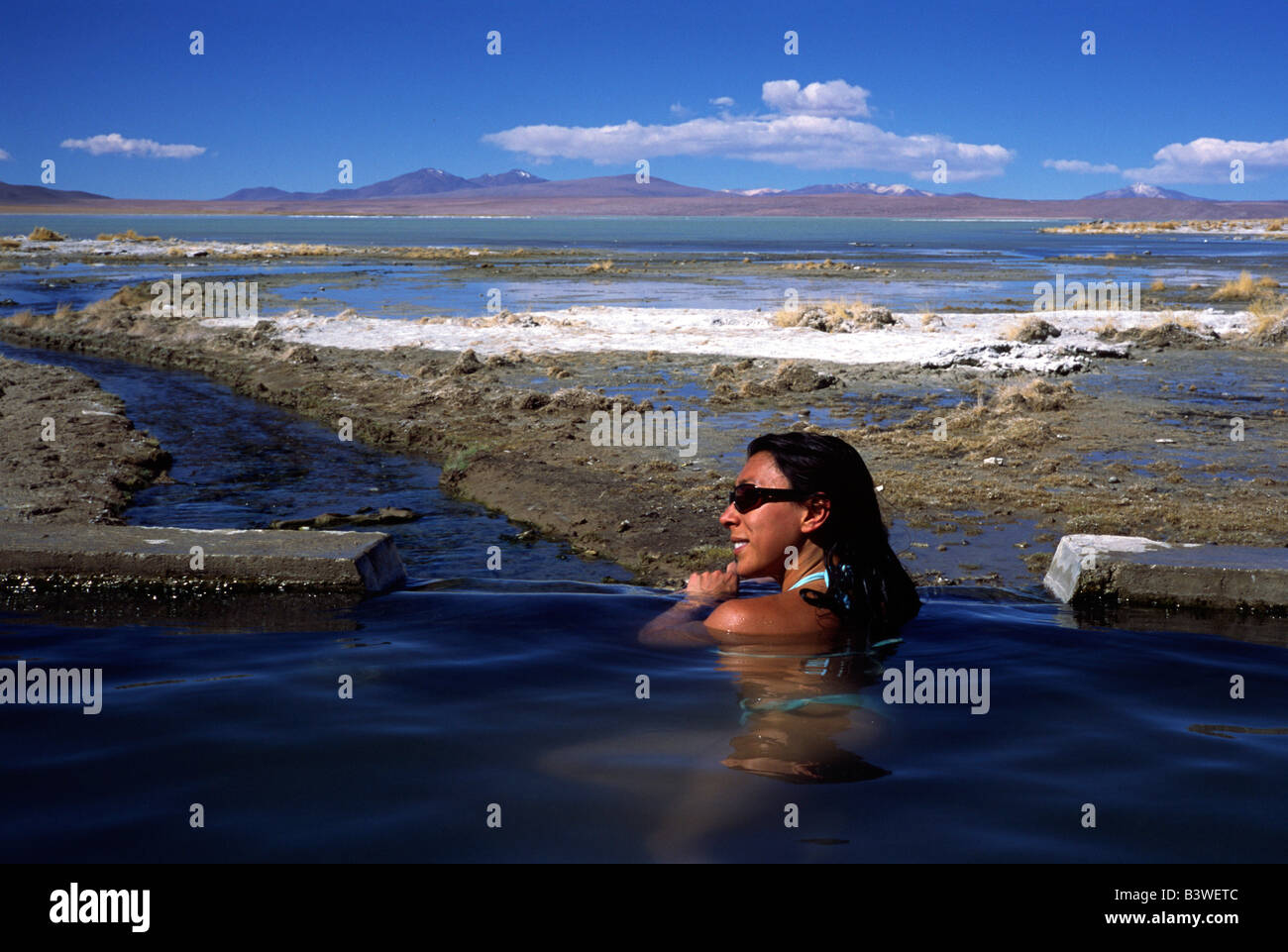 Bolivia, Aguas Calientes, Woman in bikini relaxing in the hot springs at Aguas Calientes on Southwest Circuit Tour. (MR) Stock Photo