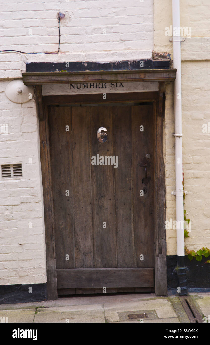 Brown rustic wooden front door of terraced cottage in Ludlow Shropshire England UK Stock Photo
