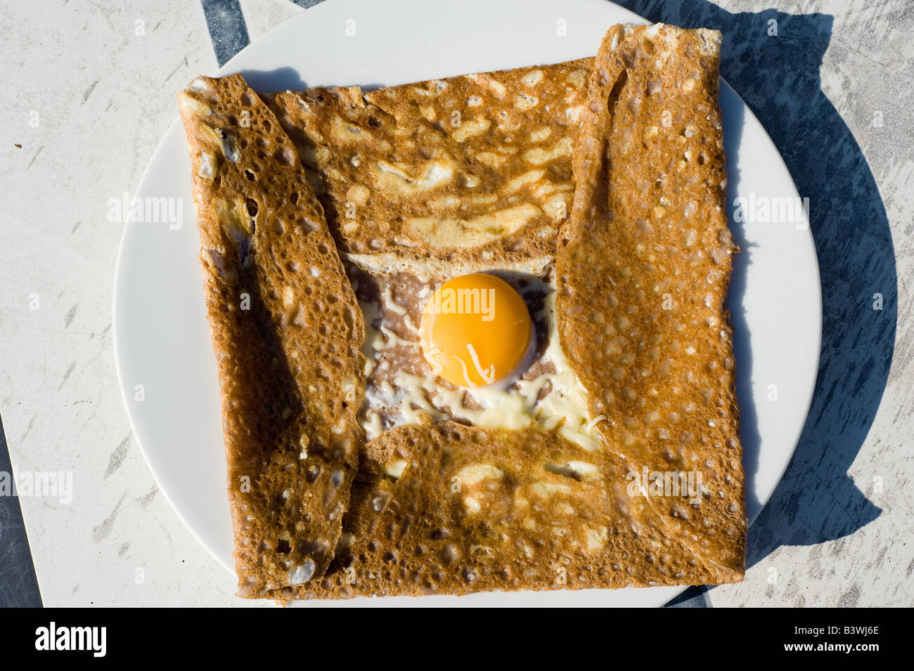 Galette de sarrasin complète, buckwheat crepe with ham, cheese and fried egg, french Brittany cuisine, France, Europe Stock Photo