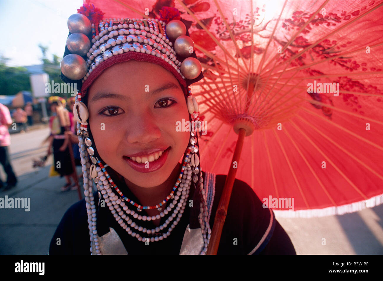 Portrait of an Akha tribal woman holding a parasol and smiling, Chiang Rai, Chiang Rai Province, Thailand Stock Photo