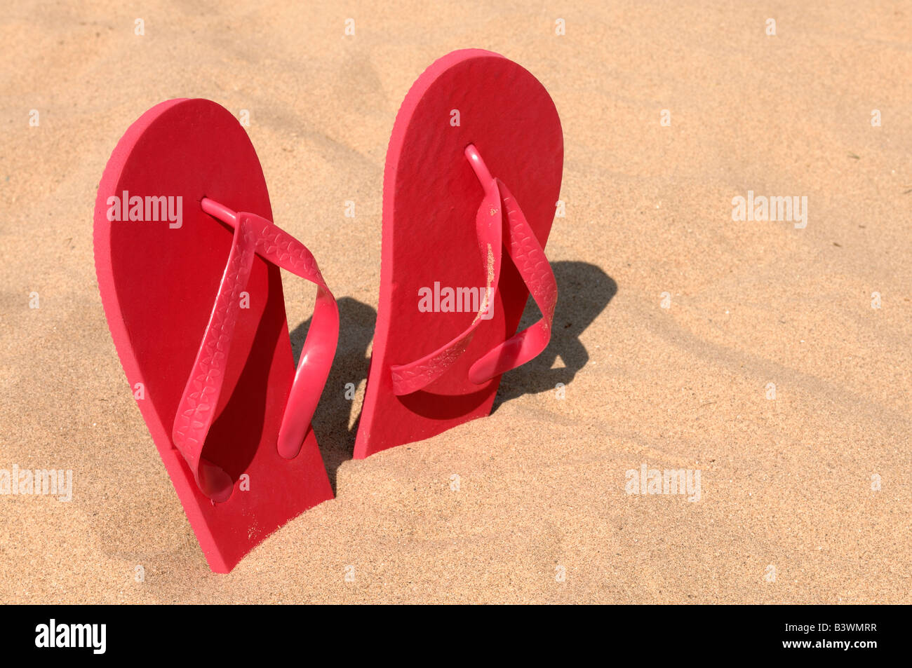 Pink flip flops in sand Stock Photo - Alamy