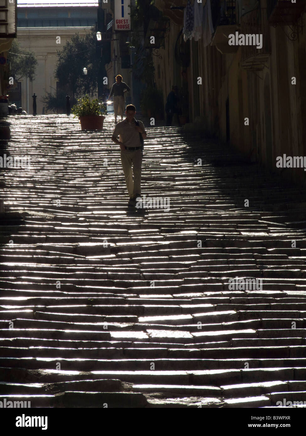 Two men walking down staircase hi-res stock photography and images - Alamy